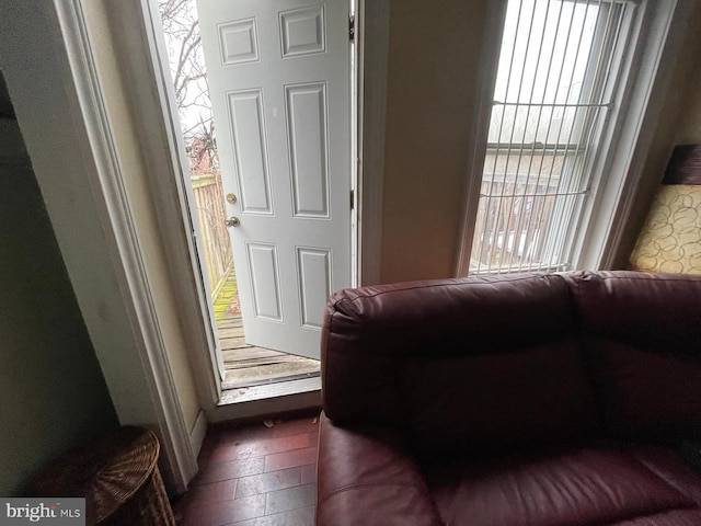 interior space with plenty of natural light and dark hardwood / wood-style floors