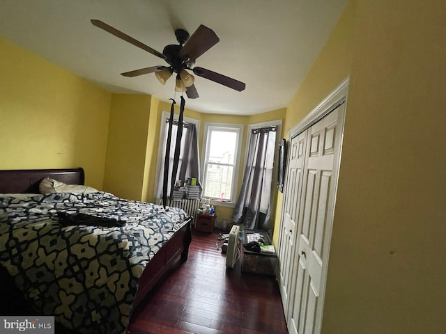 bedroom with dark hardwood / wood-style floors and ceiling fan