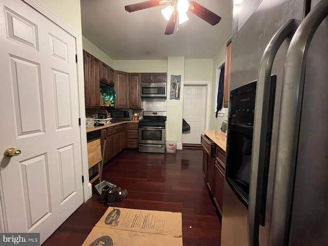 kitchen featuring dark brown cabinets, ceiling fan, dark hardwood / wood-style flooring, and stainless steel appliances