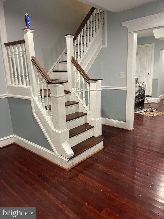 stairs featuring hardwood / wood-style flooring