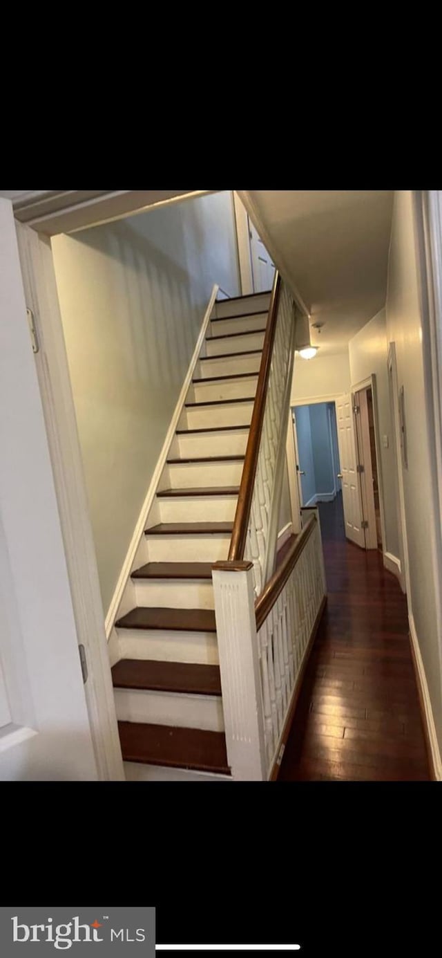 stairs featuring hardwood / wood-style flooring