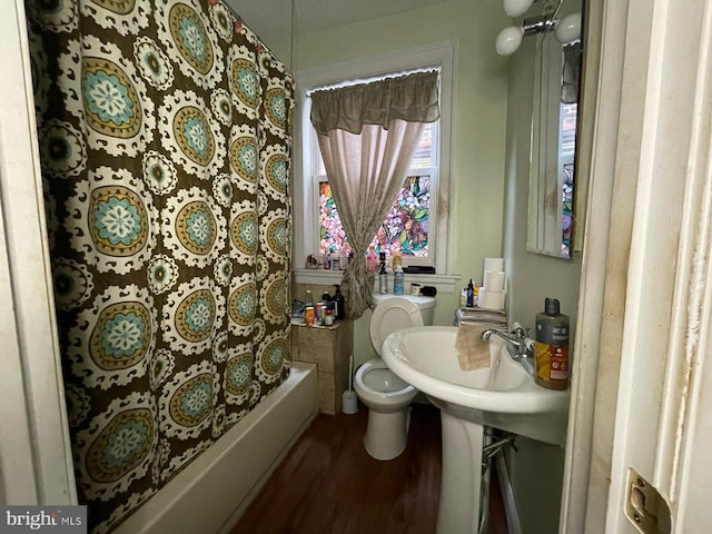 bathroom with shower / bath combo, toilet, and wood-type flooring