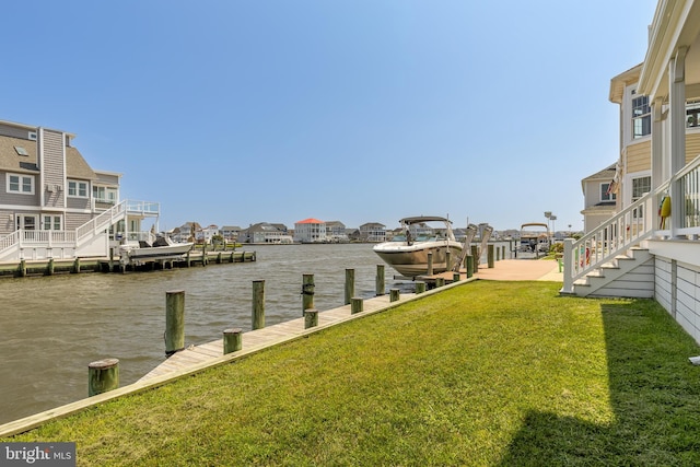 dock area featuring a water view and a lawn