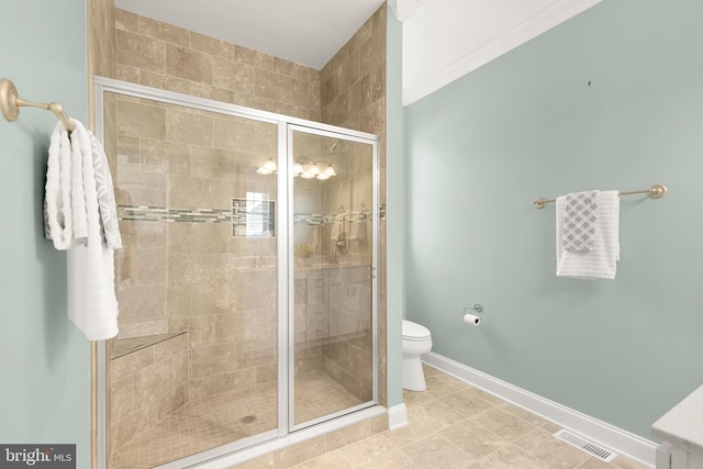 bathroom featuring walk in shower, tile patterned floors, toilet, and crown molding