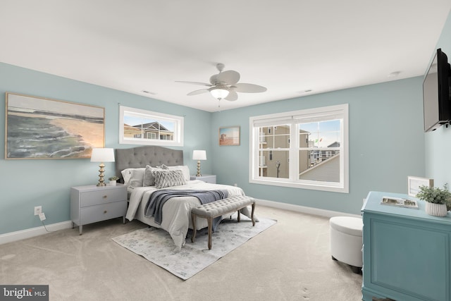 bedroom featuring light colored carpet and ceiling fan