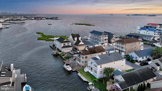 aerial view at dusk with a water view