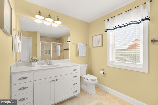 bathroom featuring a shower with door, vanity, toilet, and tile patterned flooring