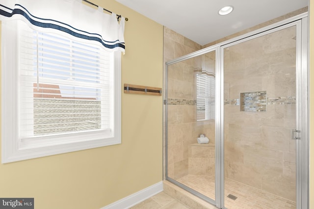 bathroom featuring a shower with door and tile patterned floors