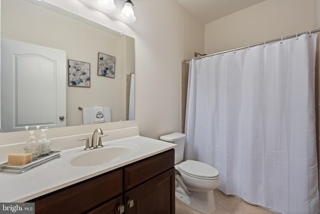 bathroom featuring tile patterned floors, vanity, a shower with shower curtain, and toilet