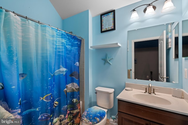 bathroom with vanity, vaulted ceiling, toilet, and curtained shower