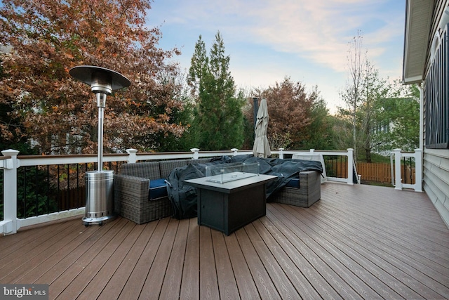 wooden terrace featuring an outdoor fire pit