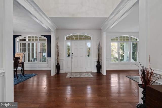 foyer featuring crown molding and dark hardwood / wood-style flooring