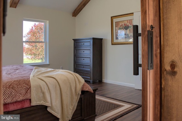 bedroom with lofted ceiling with beams and dark hardwood / wood-style floors