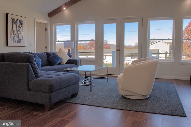 living room featuring vaulted ceiling with beams, dark wood-type flooring, and french doors