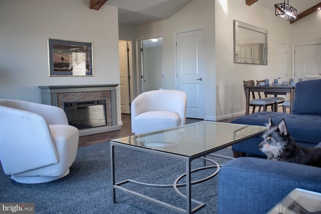 living room with vaulted ceiling with beams, a fireplace, and dark wood-type flooring