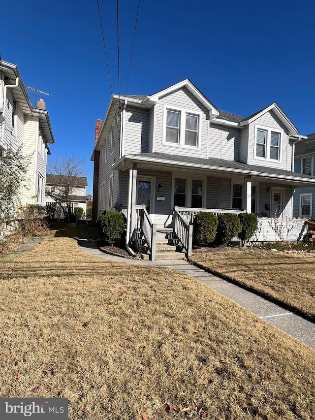 view of front of property with a porch and a front yard