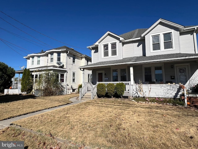 view of front of home with covered porch and a front lawn