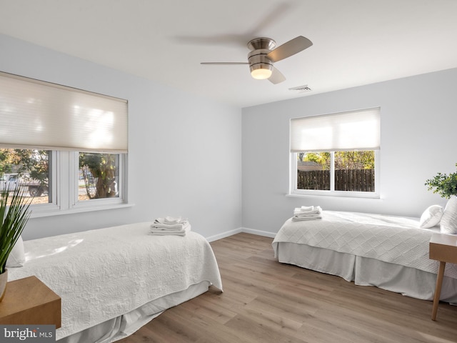 bedroom with light wood-type flooring and ceiling fan