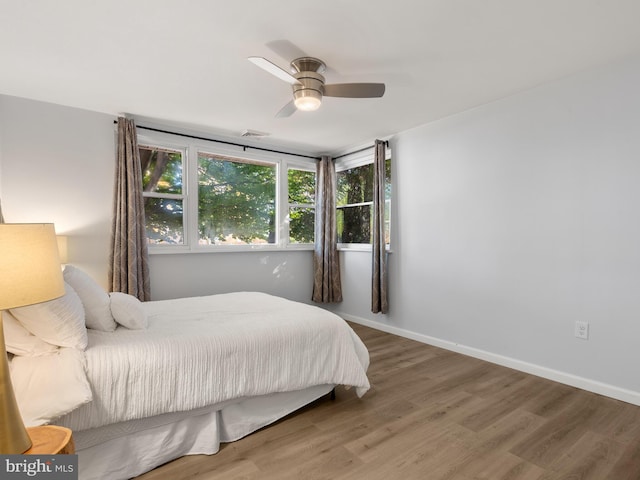 bedroom featuring wood-type flooring and ceiling fan