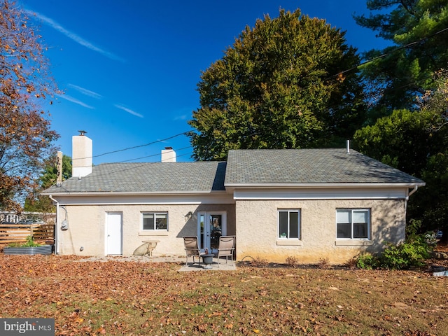 back of property with a patio