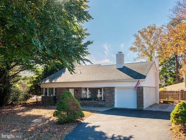 rear view of property with a garage