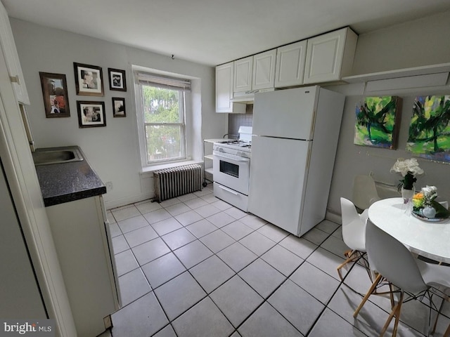 kitchen with white cabinetry, sink, light tile patterned floors, white appliances, and radiator heating unit