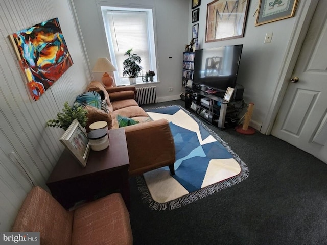 living room with radiator, carpet, and wooden walls