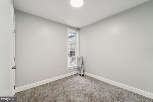 carpeted empty room with radiator