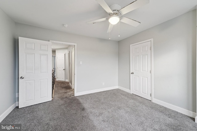 unfurnished bedroom featuring ceiling fan and dark colored carpet