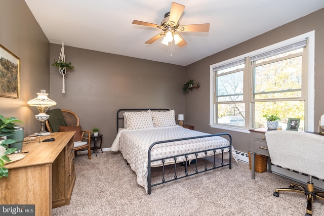 bedroom featuring multiple windows, a baseboard heating unit, light colored carpet, and ceiling fan