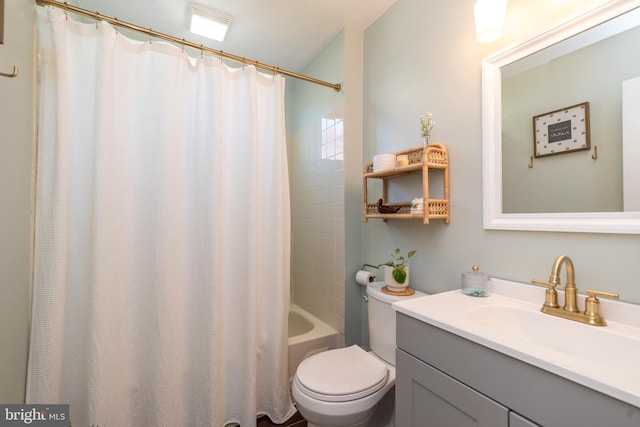 full bathroom with vanity, shower / bath combo, and toilet