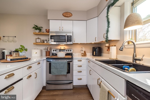 kitchen featuring dark hardwood / wood-style flooring, sink, white cabinets, and appliances with stainless steel finishes