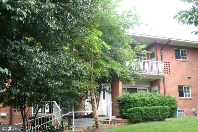 exterior space with central air condition unit and a balcony