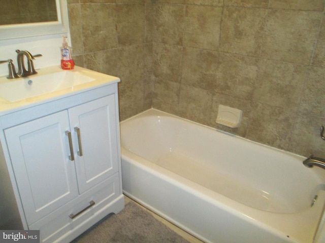 bathroom featuring a tub to relax in and vanity