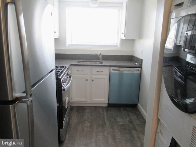 kitchen with white cabinets, stainless steel appliances, dark wood-type flooring, and sink