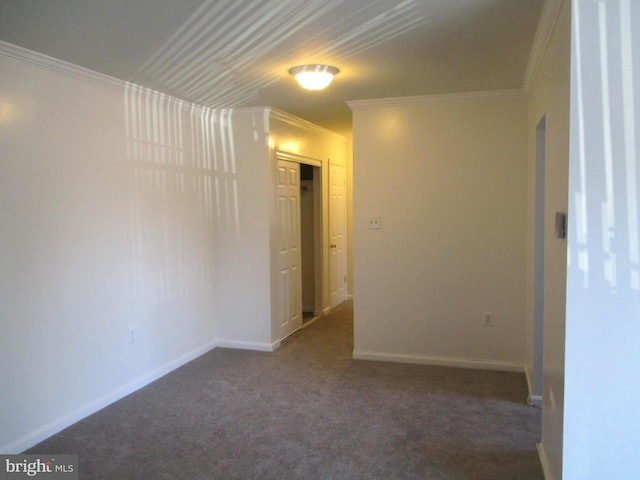 empty room with crown molding and dark carpet