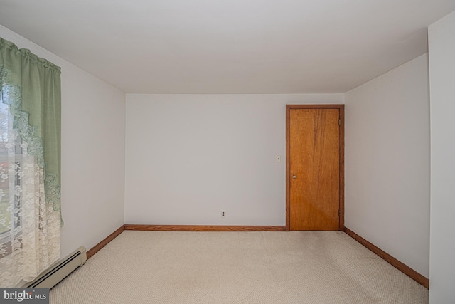 carpeted empty room with baseboard heating