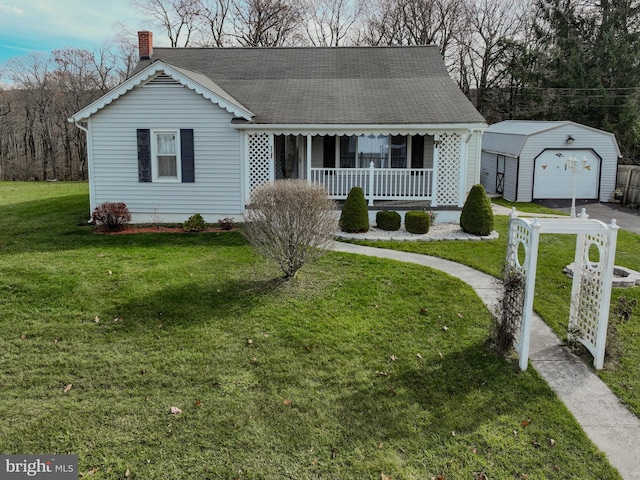 view of front of property with a front yard, an outdoor structure, covered porch, and a garage