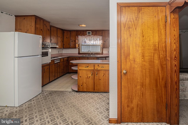 kitchen with white appliances and sink