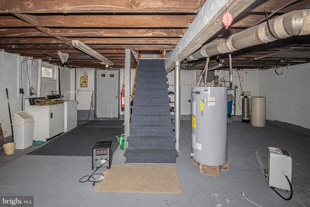 basement featuring washing machine and clothes dryer and water heater