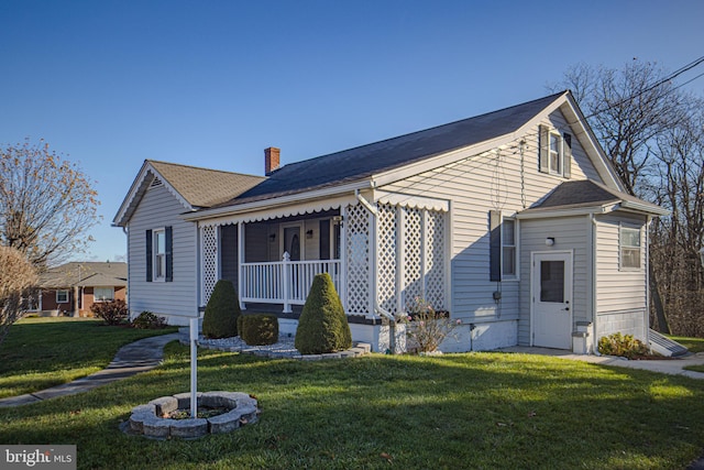 view of front of property with a porch and a front yard