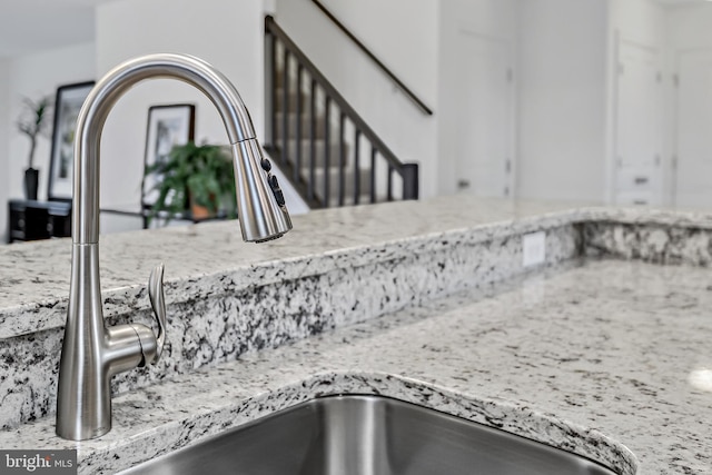 room details featuring sink and light stone counters