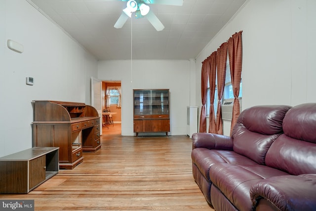 living room with ceiling fan, ornamental molding, and light hardwood / wood-style flooring