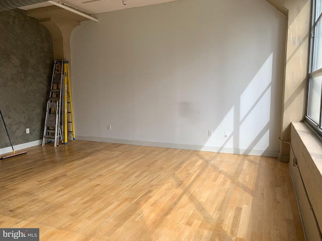 unfurnished room with light hardwood / wood-style floors