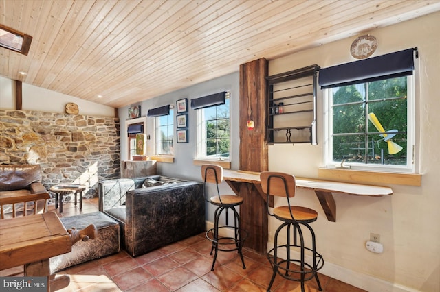 interior space featuring wood ceiling, light tile patterned floors, and lofted ceiling