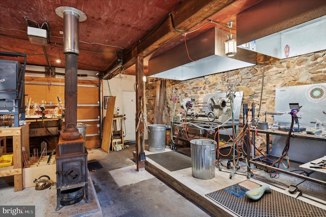 miscellaneous room with concrete flooring and a workshop area