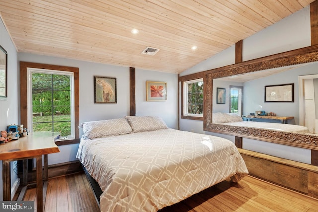 bedroom with lofted ceiling, hardwood / wood-style floors, and wooden ceiling