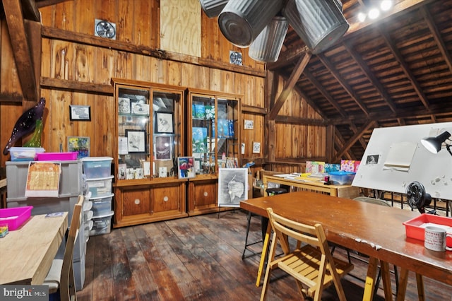 interior space featuring high vaulted ceiling, wooden walls, dark hardwood / wood-style floors, and beam ceiling