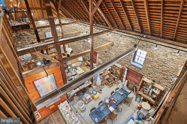 unfurnished living room with high vaulted ceiling