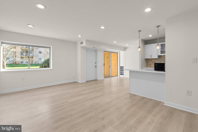 unfurnished living room featuring light wood-type flooring